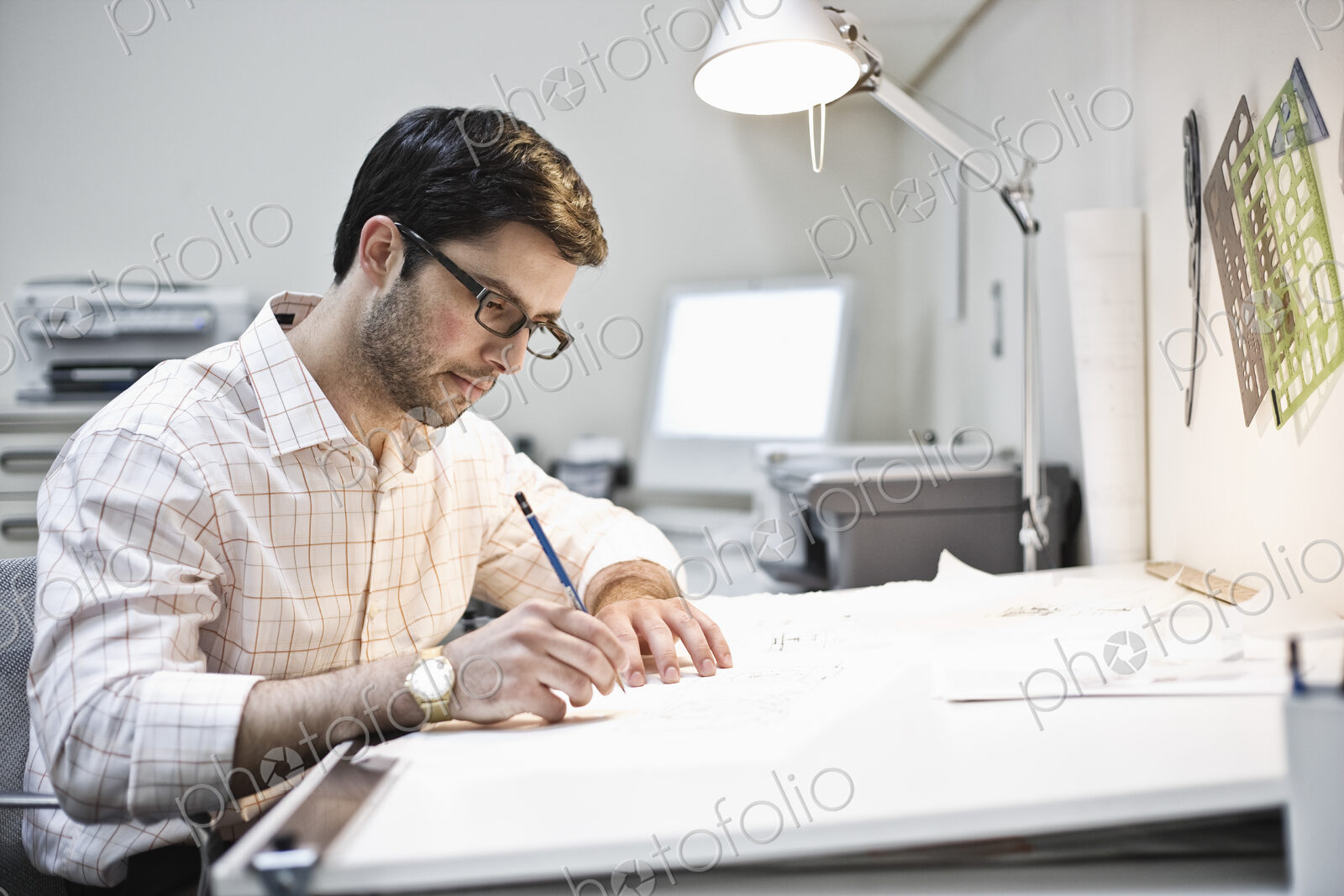 Hispanic man working in an architect’s office.