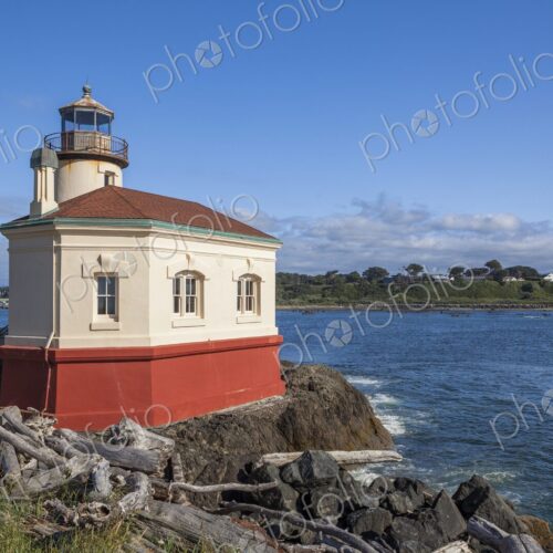 Historic Coquille River Lighthouse in Bandon, Oregon, stands on rocky shore with… Historic Coquille River Lighthouse in Bandon, Oregon, stands on rocky shore with…