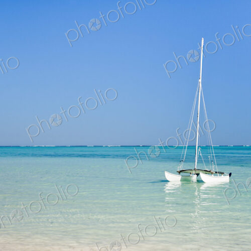 Hobie cat sailing boat in the lagoon off the shore at Tsifota. Hobie cat sailing boat in the lagoon off the shore at Tsifota.