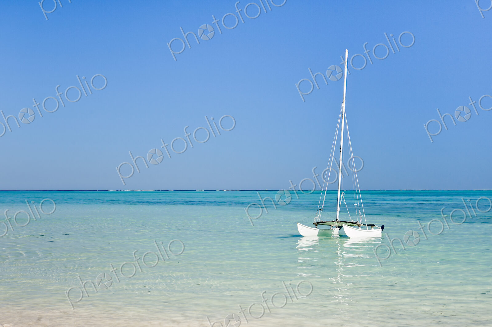 Hobie cat sailing boat in the lagoon off the shore at Tsifota.