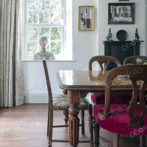 Home interior, antique bust on window near dining table Home interior, antique bust on window near dining table
