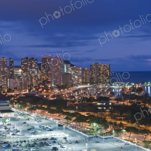 Honolulu, Waikiki, an elevated view of the downtown area and the waterfront at night. Honolulu, Waikiki, an elevated view of the downtown area and the waterfront at night.