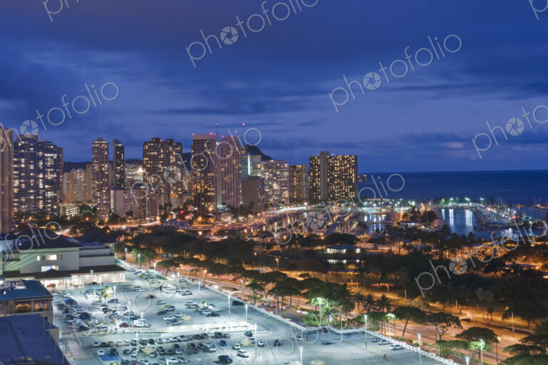 Honolulu, Waikiki, an elevated view of the downtown area and the waterfront at night.
