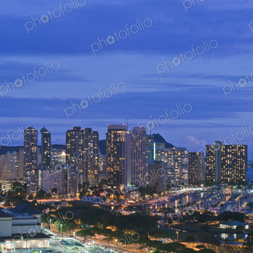 Honolulu, Waikiki, an elevated view of the downtown area and the waterfront at night. Honolulu, Waikiki, an elevated view of the downtown area and the waterfront at night.
