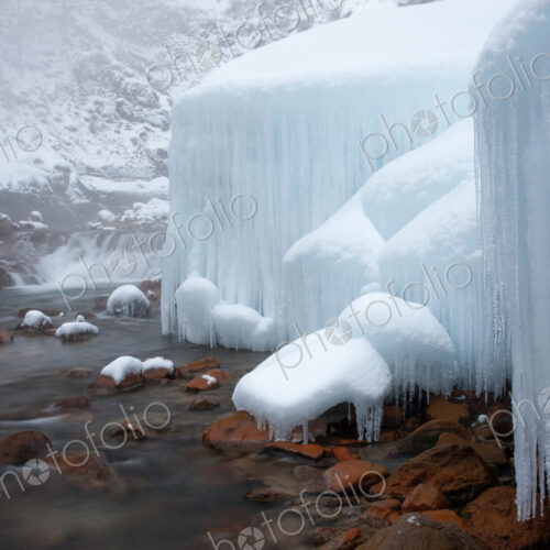 Honshu island, Nagano, Japan. Icicles and blocks of frozen snow by a stream. Honshu island, Nagano, Japan. Icicles and blocks of frozen snow by a stream.