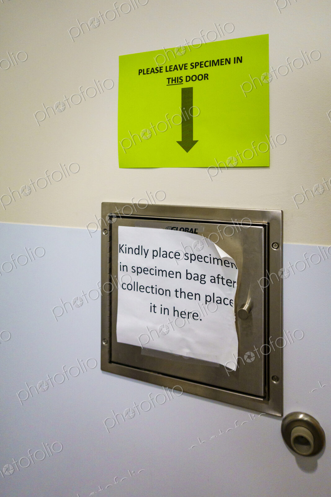 Hospital specimen deposit drawer, an instruction sign and arrow.