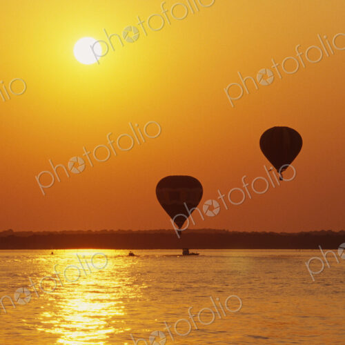 Hot Air Balloons Over Water at Sunset Hot Air Balloons Over Water at Sunset