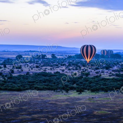 Hot air balloon flying over savanna landscape Hot air balloon flying over savanna landscape