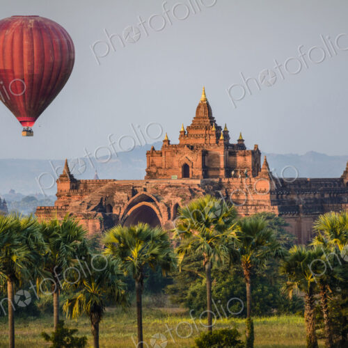 Hot air balloon flying over temple Hot air balloon flying over temple