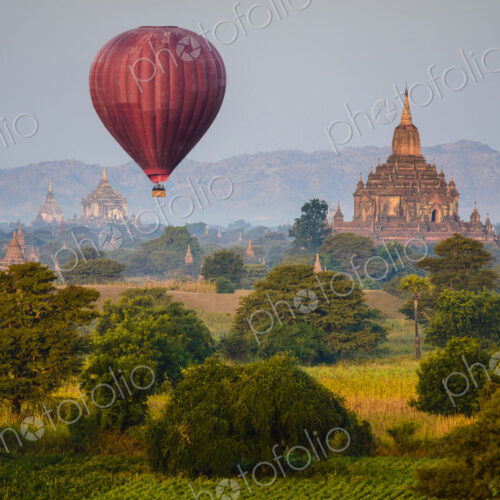 Hot air balloon flying over towers Hot air balloon flying over towers