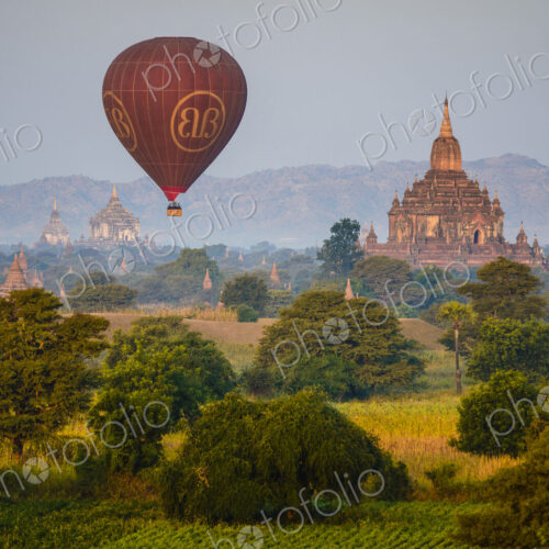 Hot air balloon in the air above a temple in Mandalay. Hot air balloon in the air above a temple in Mandalay.