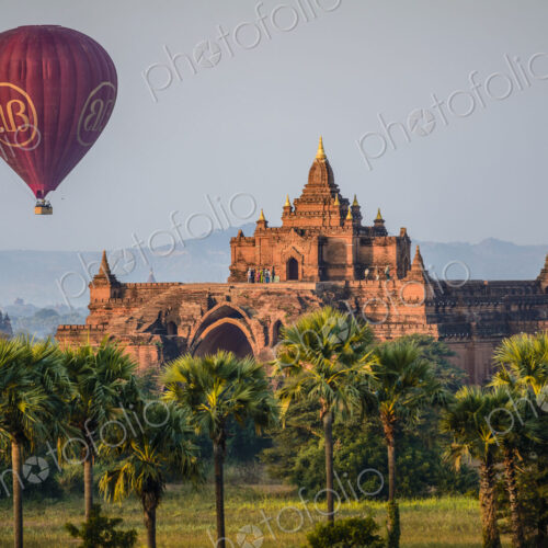 Hot air balloon in the air above a temple in Mandalay. Hot air balloon in the air above a temple in Mandalay.