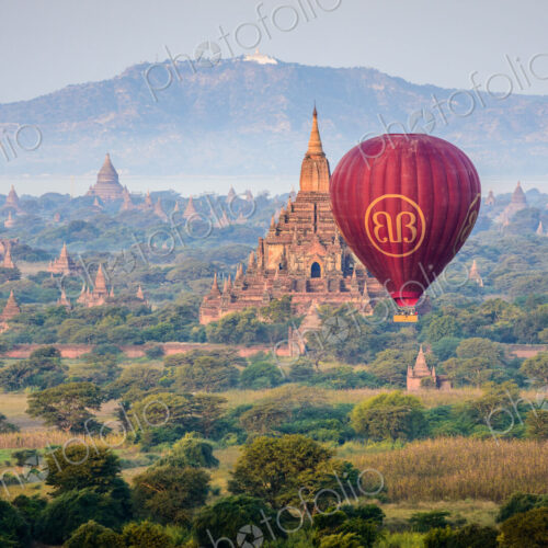 Hot air balloon in the air above the plain of temples in Mandalay Hot air balloon in the air above the plain of temples in Mandalay