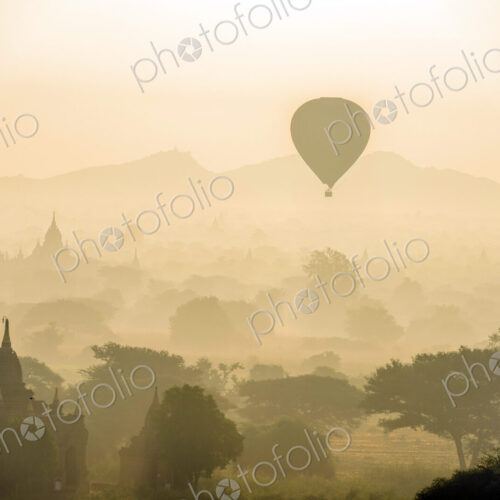 Hot air balloon in the air above the plain of temples in Mandalay Hot air balloon in the air above the plain of temples in Mandalay