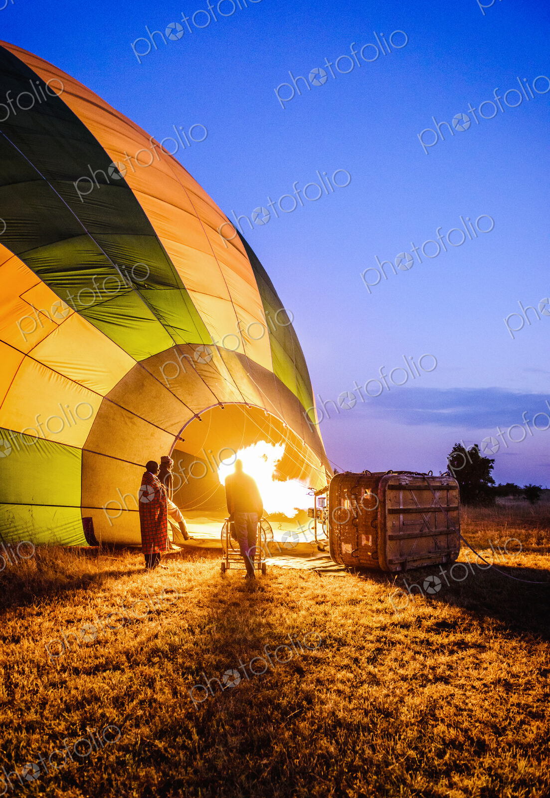 Hot air balloon inflating in rural field