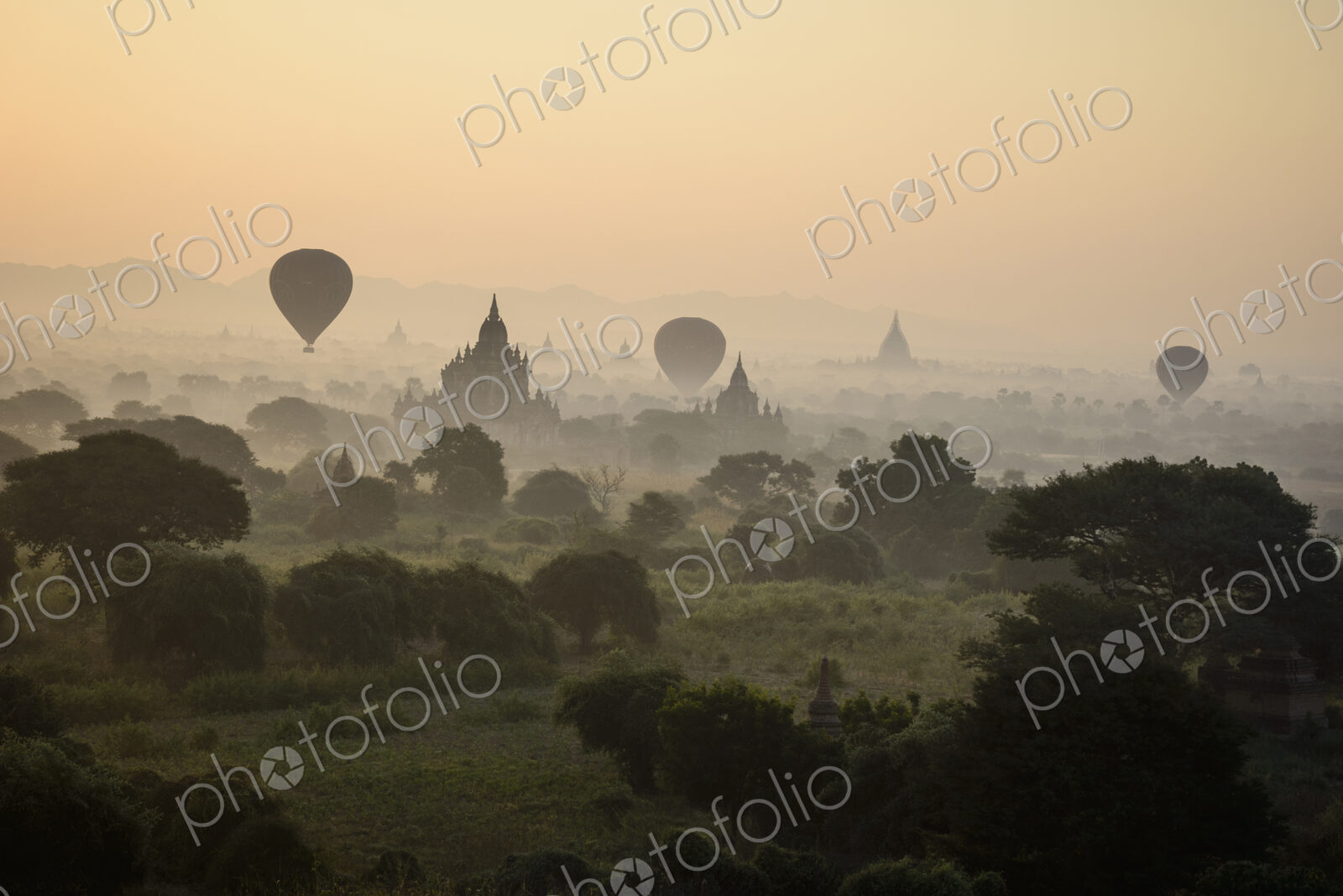 Hot air balloons hovering in the air above the plain of temples in Mandalay