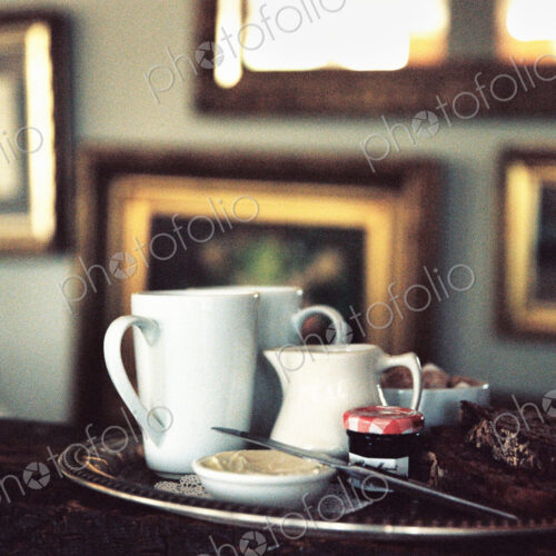 Hotel, A tea tray on a table in a room full of pictures. Hotel, A tea tray on a table in a room full of pictures.