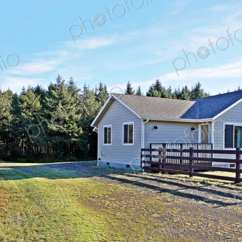 House and fenced yard in rural setting