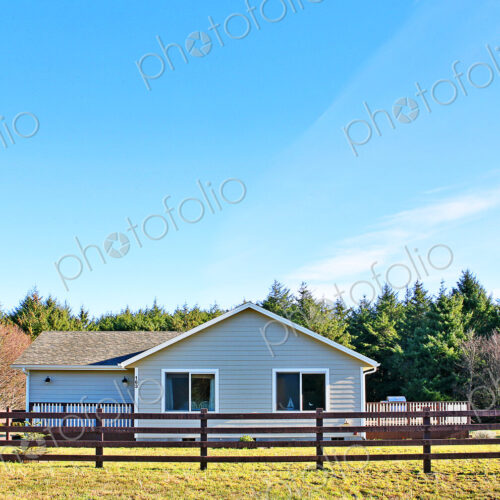House and fenced yard in rural setting