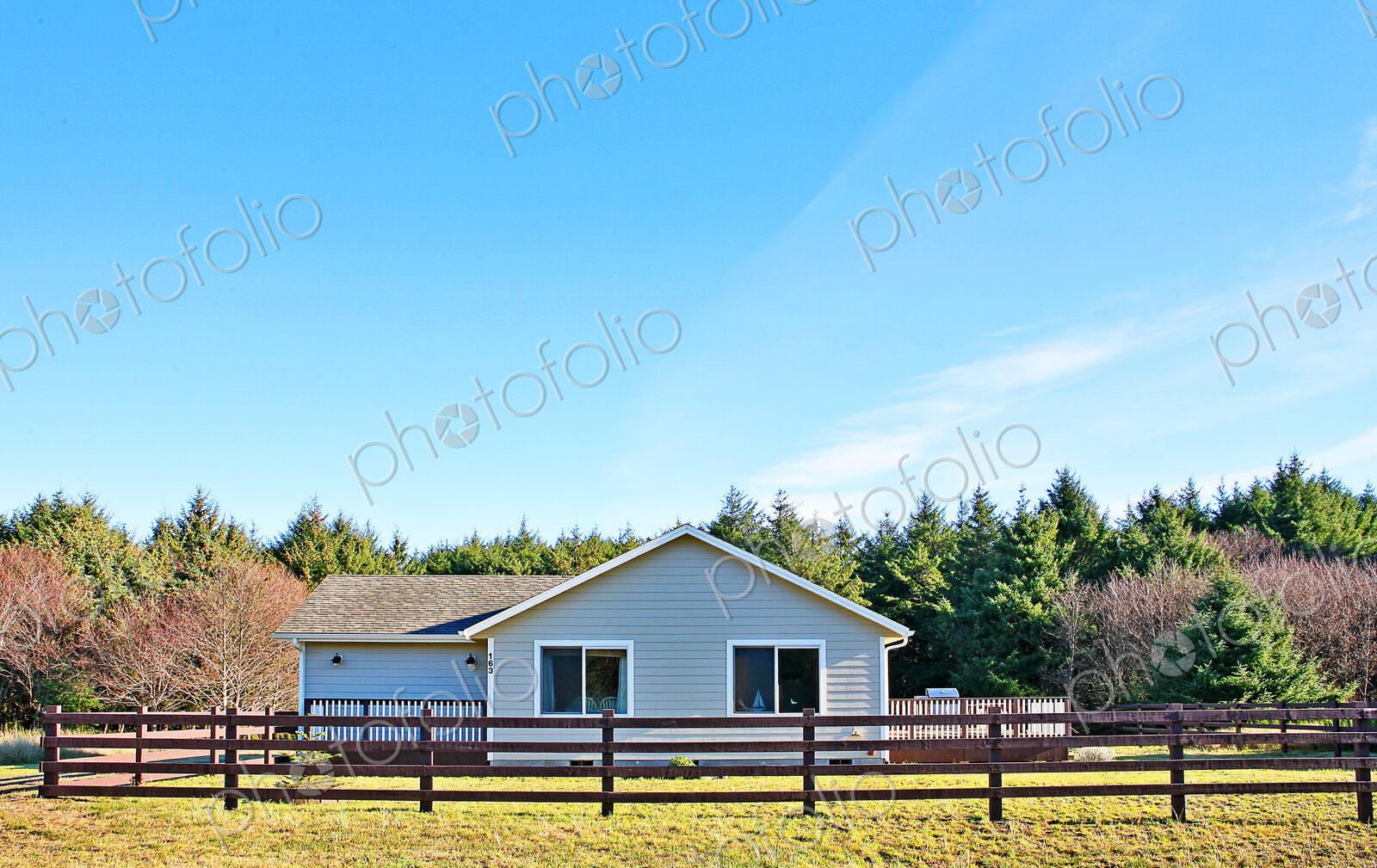 House and fenced yard in rural setting