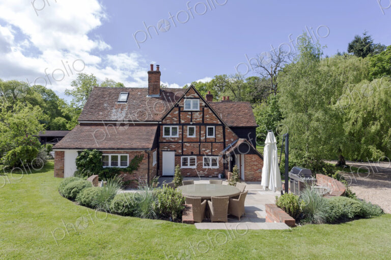 House and manicured backyard lawn