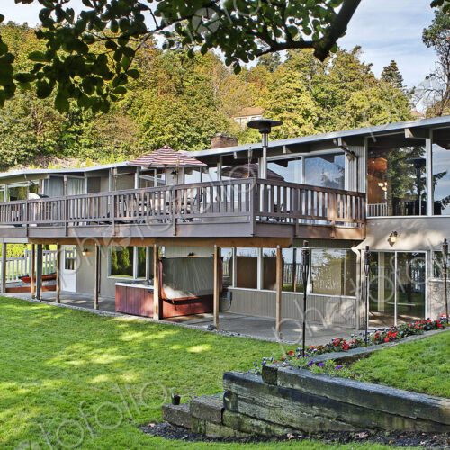 House with elevated deck and backyard
