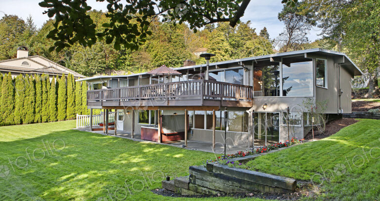 House with elevated deck and backyard
