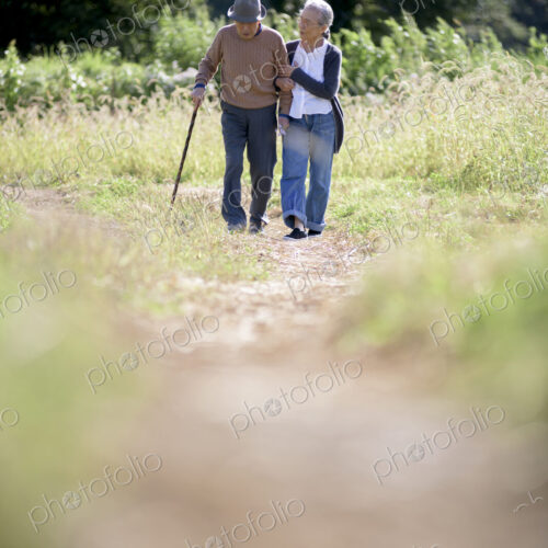 Husband and wife, elderly man wearing hat and using walking stick and elderly woman… Husband and wife, elderly man wearing hat and using walking stick and elderly woman…