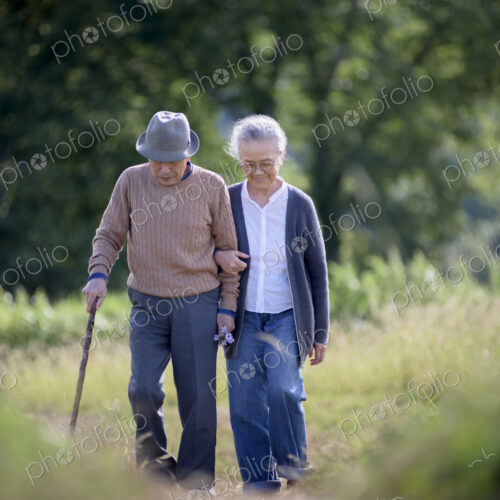 Husband and wife, elderly man wearing hat and using walking stick and elderly woman… Husband and wife, elderly man wearing hat and using walking stick and elderly woman…