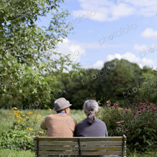 Husband and wife, rear view of elderly man wearing hat and woman sitting side by side… Husband and wife, rear view of elderly man wearing hat and woman sitting side by side…