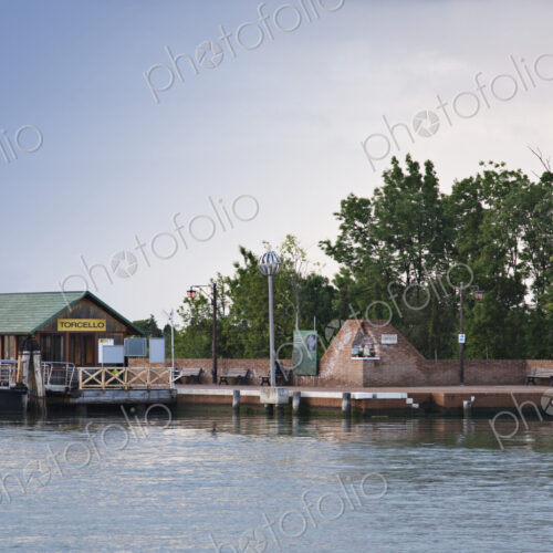 Hut and wall on waterfront. Hut and wall on waterfront.