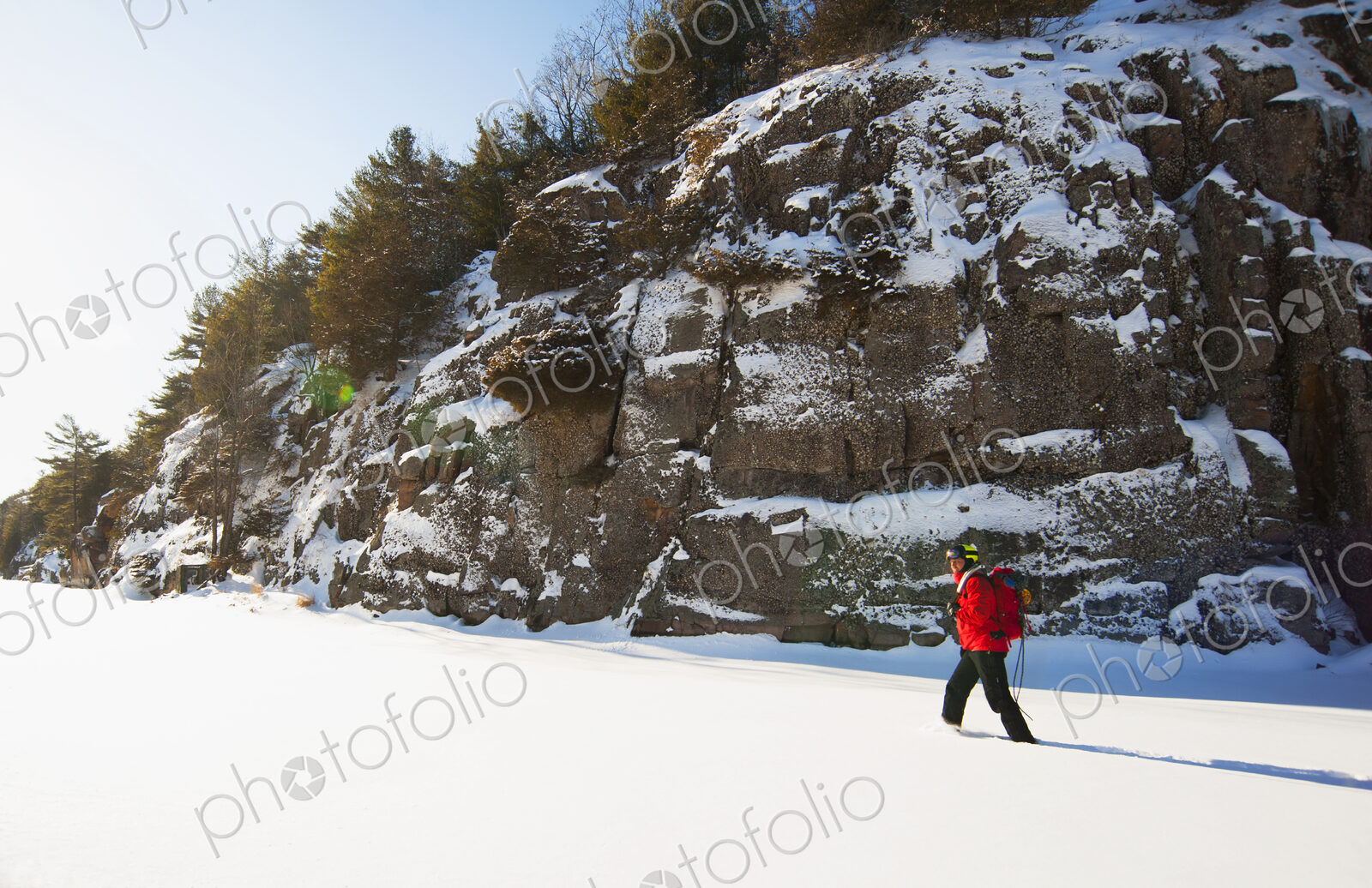 Ice climber walking in snowy field