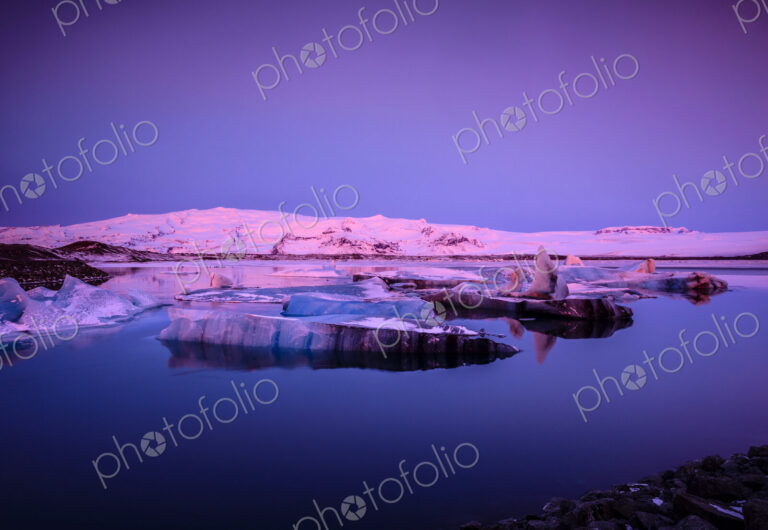 Ice floes in Iceland in pink light at dusk.