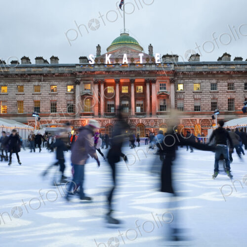 Ice skaters on the ice rink in the courtyard of Somerset House, London, UK.