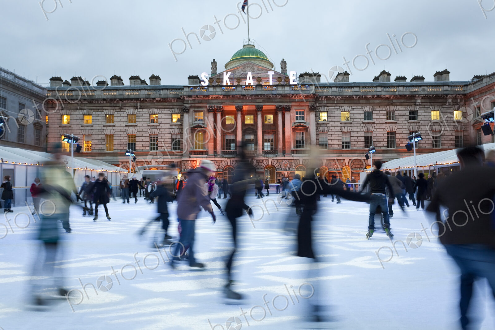Ice skaters on the ice rink in the courtyard of Somerset House, London, UK.