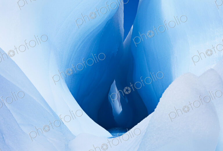 Icebergs and ice formations in the Antarctic. A large fissure or hole in the centre of…