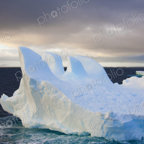 Icebergs floating on the Antarctic southern oceans. Eroded by wind and weather,… Icebergs floating on the Antarctic southern oceans. Eroded by wind and weather,…