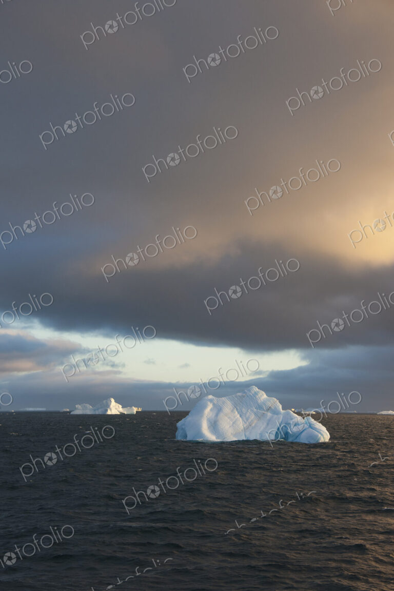 Icebergs on the waters of the Weddell Sea in the Southern Ocean at sunset.