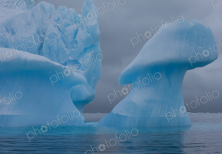 Icebergs with eroding and changing form drifting on the water, Antarctica