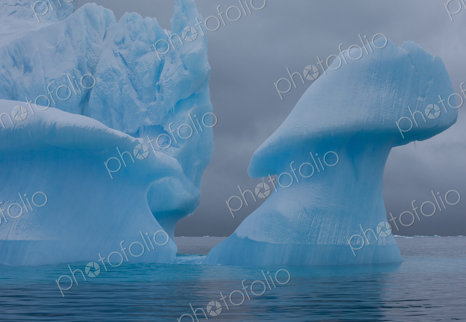 Icebergs with eroding and changing form drifting on the water, Antarctica
