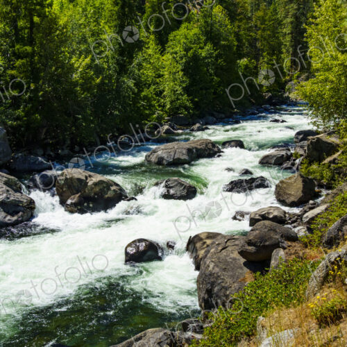 Icicle Creek, a view of the white water flowing down over rocks in a gorge.