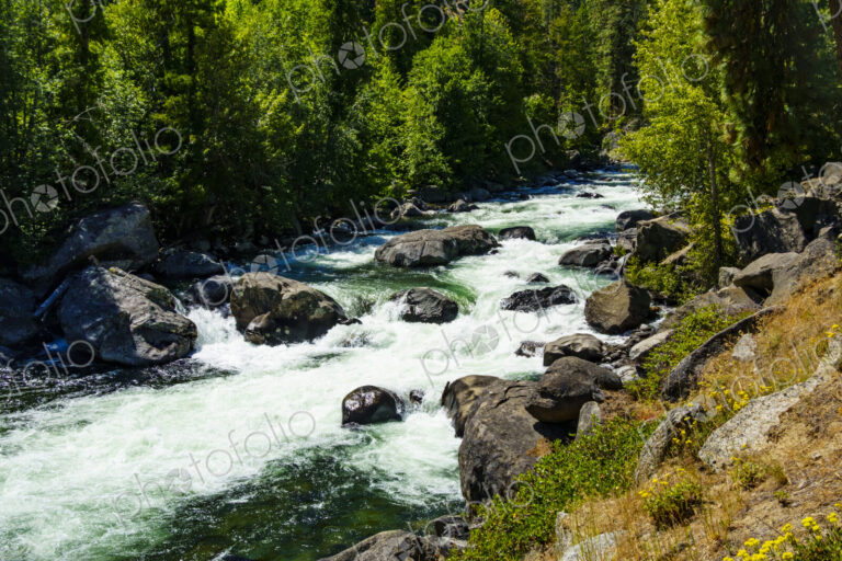 Icicle Creek, a view of the white water flowing down over rocks in a gorge.