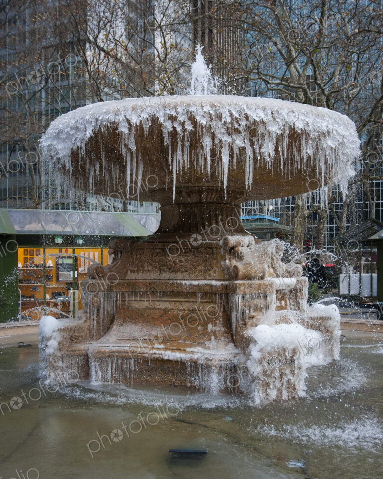 Icicles suspended from the frozen Josephine Shaw Lowell Memorial Fountain in Bryant…