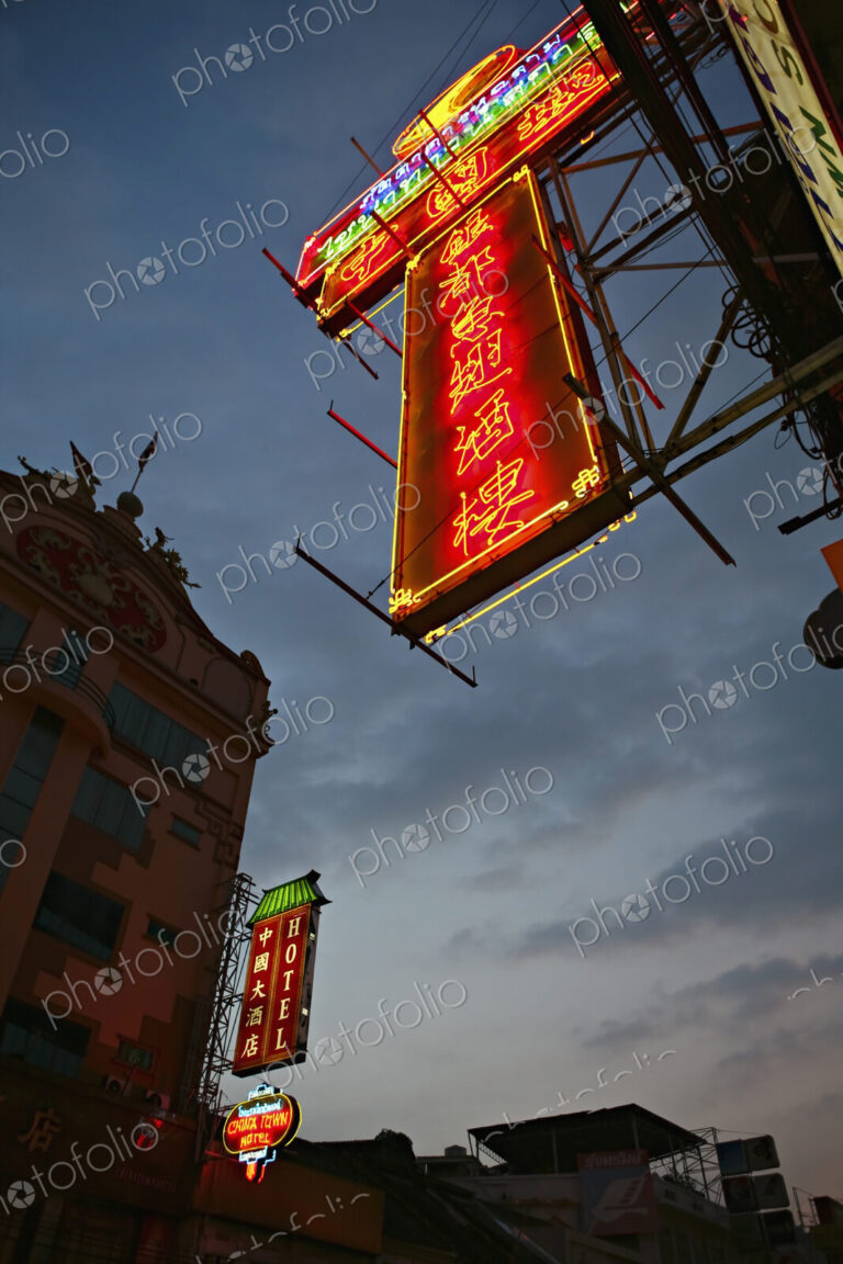 Illuminated Chinatown Street signs in Bangkok at night.