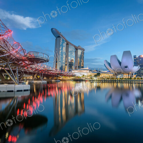 Illuminated Singapore waterfront in the evening, with Marina Bay Sands Hotel and… Illuminated Singapore waterfront in the evening, with Marina Bay Sands Hotel and…