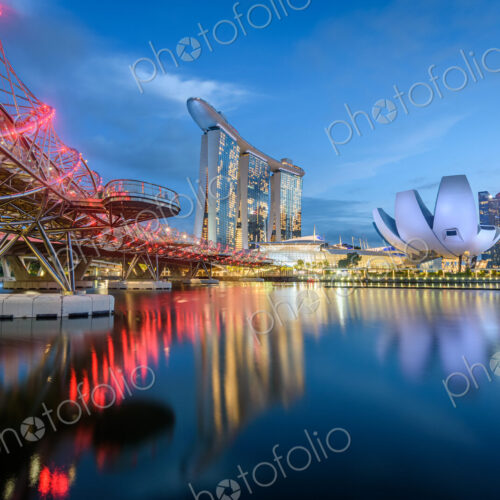 Illuminated Singapore waterfront in the evening, with Marina Bay Sands Hotel and… Illuminated Singapore waterfront in the evening, with Marina Bay Sands Hotel and…