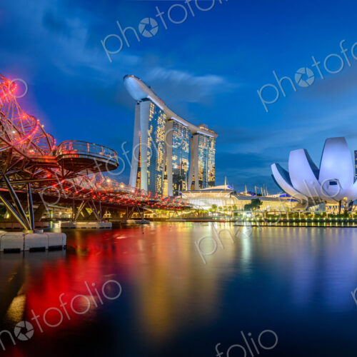 Illuminated Singapore waterfront in the evening, with Marina Bay Sands Hotel and… Illuminated Singapore waterfront in the evening, with Marina Bay Sands Hotel and…