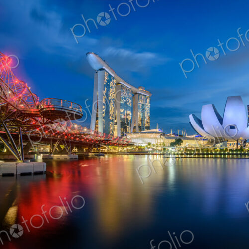 Illuminated Singapore waterfront in the evening, with Marina Bay Sands Hotel and… Illuminated Singapore waterfront in the evening, with Marina Bay Sands Hotel and…