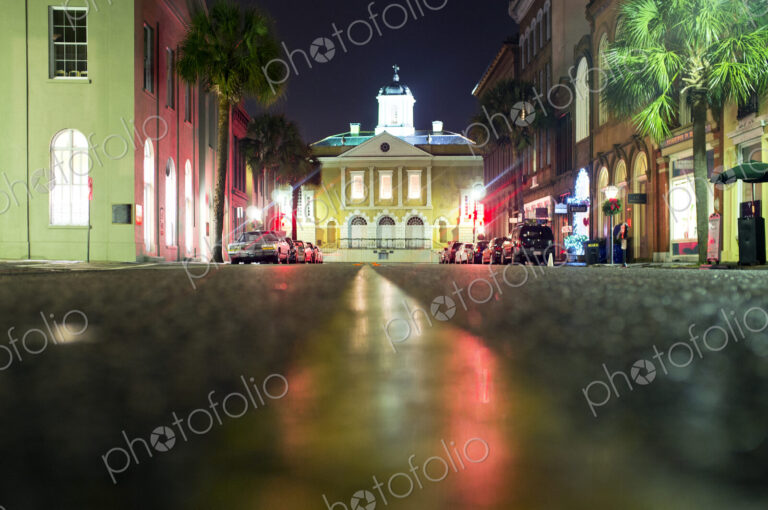 Illuminated buildings along city street at night, Charleston, South Carolina, United…