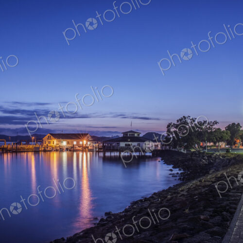 Illuminated buildings on water at dawn Illuminated buildings on water at dawn